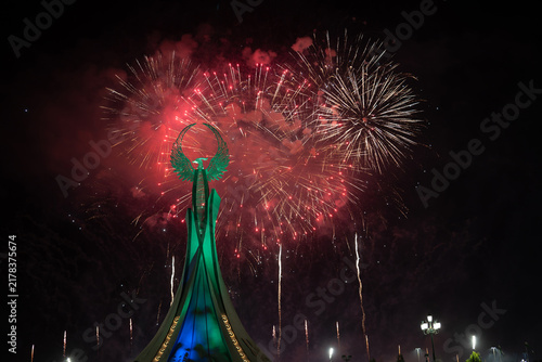 Spectacular colorful fireworks illuminating the Humo Bird Stella in Yangi Uzbekistan, Tashkent, Uzbekistan, at night. Dramatic festive scene featuring the iconic national symbol against a vibrant illu