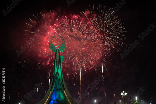 Spectacular colorful fireworks illuminating the Humo Bird Stella in Yangi Uzbekistan, Tashkent, Uzbekistan, at night. Dramatic festive scene featuring the iconic national symbol against a vibrant illu