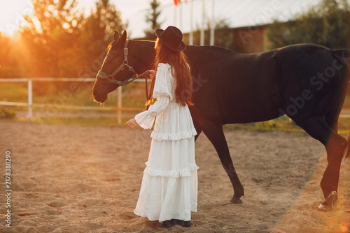 Konstfotografi Woman with her horse at outdoors ranch