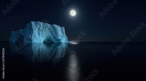 Massive glowing blue iceberg floating in dark arctic waters under bright full moon during clear night sky in polar region