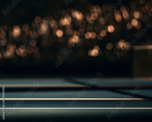 Moody, bokeh-lit court surface with blurred stadium lights in dark background