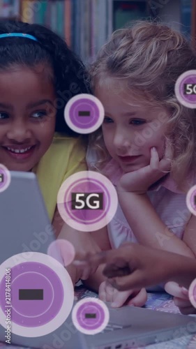 Children using laptop with 5G technology animation overlay in library setting