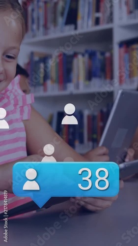 In school library, children using tablets and laptops with animation overlay
