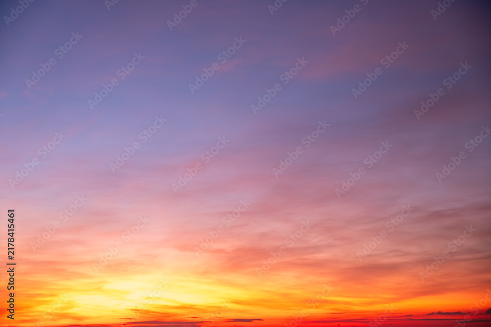 Fototapeta premium Sky sunset,Beautiful sunrise sky with vibrant gradient orange and gold colors and soft blue, Clear atmosphere with wispy clouds. Peaceful, perfect for background and copy space, High resolution images
