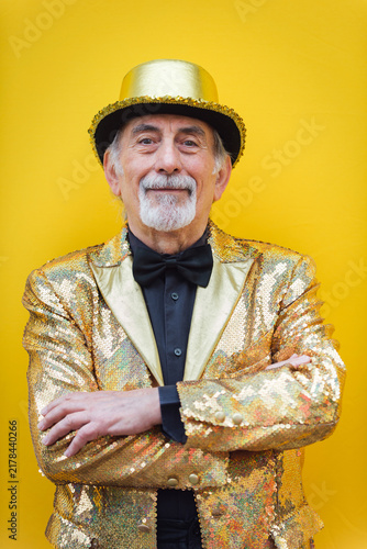 Eccentric senior man portrait - cool and modern old man wearing colorful stylish clothing on colored background