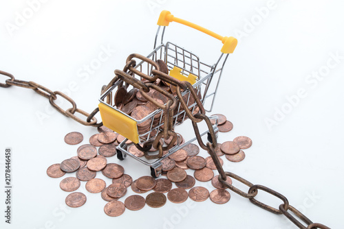 Bild auf Leinwand Chained Shopping Cart with Pennies Symbolizing Consumer Debt and Spending Contro