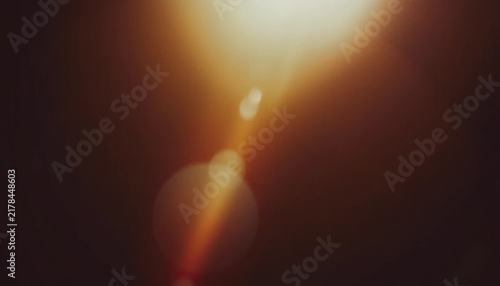 Obraz na płótnie Warm lens flare and light leak background with soft bokeh glow and dark brown tones, cinematic abstract texture for photography, posters, overlays and digital design