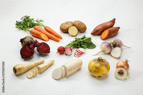Assorted fresh root vegetables on a surface