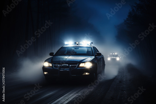 911 emergency response as police car speeds through dense night fog