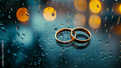 Rings reflect light on a rainy car.