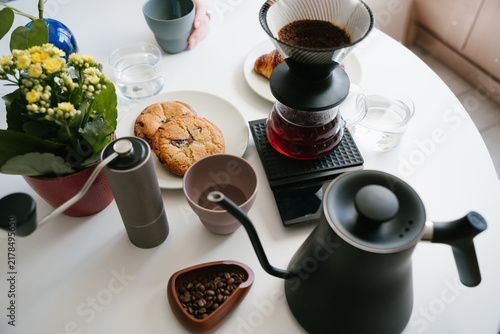 Quadro su tela Manual V60 pour over coffee brewing with paper filter, fresh ground coffee, hand