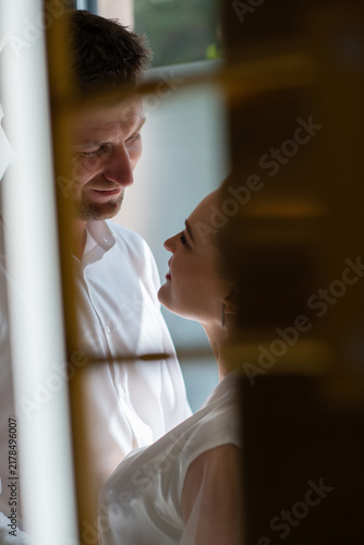 Romantic wedding portrait of a bride and groom sharing an intimate moment in