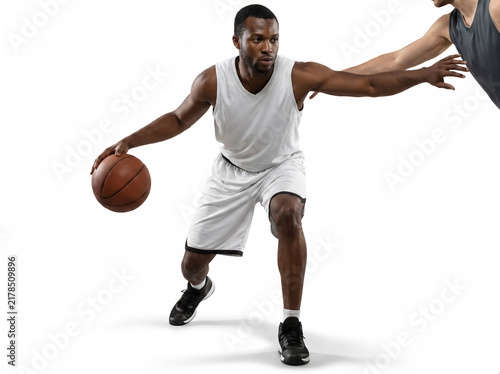Two athletes practicing basketball defense in studio