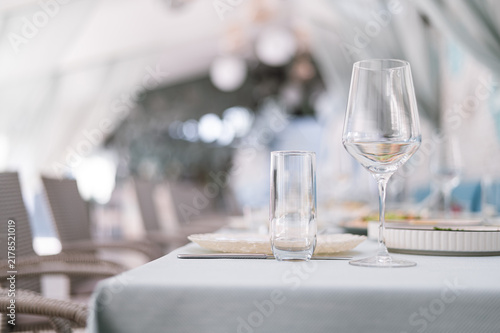 Elegant Wedding Banquet Table Setting with Dishes and Wine Glasses