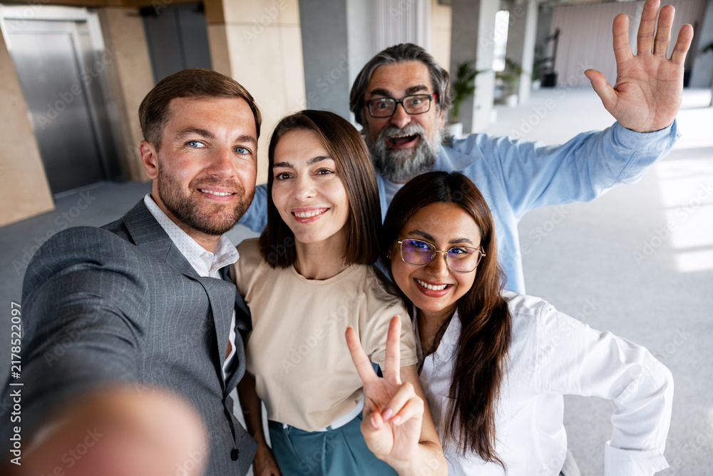 Obraz premium Happy diverse business team taking office selfie