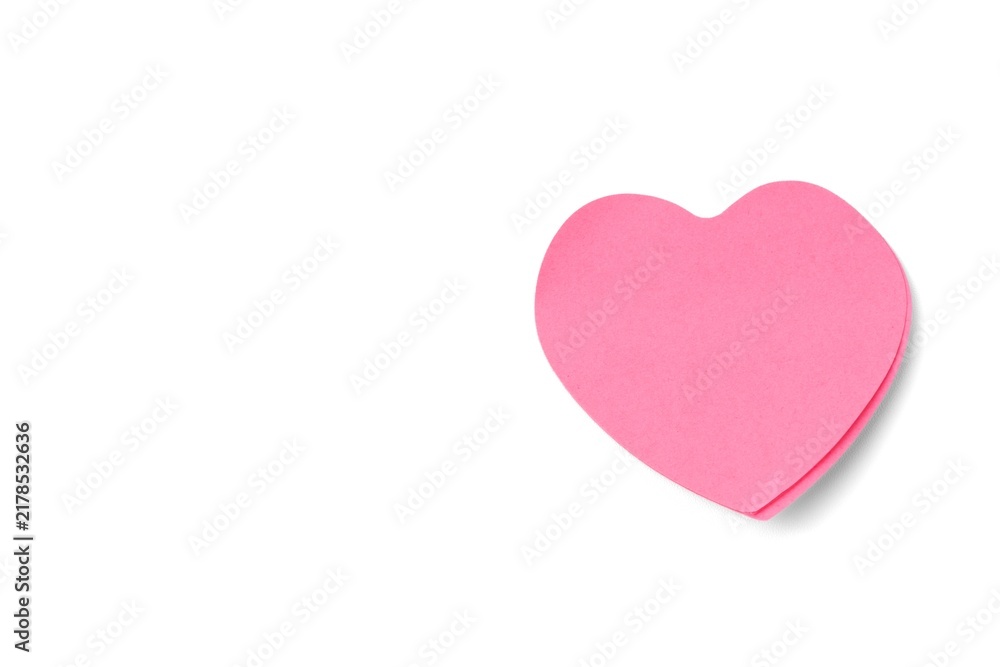 Obraz premium Pink heart shaped sticky note paper isolated on a pure white background