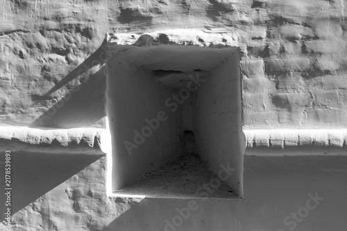 Canvas Print Old weathered white monastery fortification wall featuring a deep recessed embra