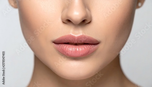 Close up portrait of a young woman with pink lipstick.
