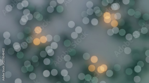 Soft golden and green bokeh lights glimmering on defocused pine branches against a muted grey background