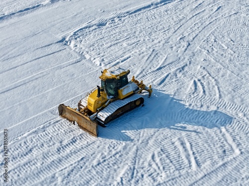 Bulldozer on a snow-covered construction site, construction industry, building trade, construction companies