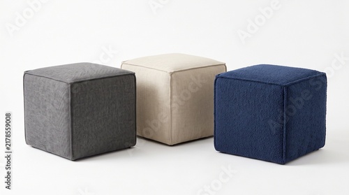Three square fabric ottoman poufs in grey beige and navy blue isolated on white background