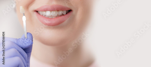 Konstfotografi Female caucasian adult smiling during dental veneer matching process, stomatolog