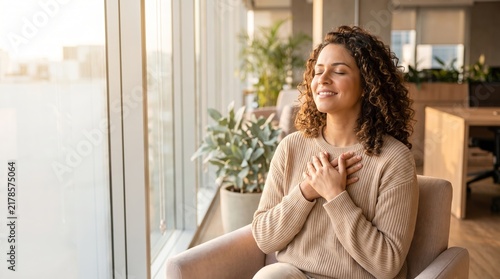 Mindful Break: Peaceful Businesswoman Meditating with Hands on Chest in Office Lounge
