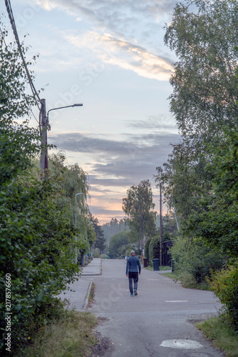 Canvas Print man walking on the misty road in the city, nacka,sverige,sweden,stockholm,summer