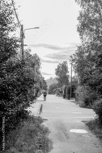 Canvas Print man walking on the misty road in the city, nacka,sverige,sweden,stockholm,summer