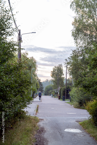 Photography man walking on the misty road in the city, nacka,sverige,sweden,stockholm,summer