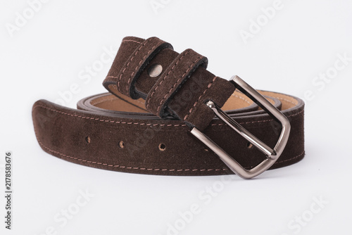 Dark brown suede leather belt coiled with a matte silver metal buckle on a white background