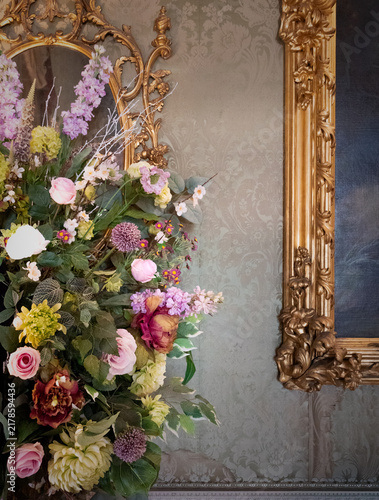Large Floral Arrangement By An Ornate Gold Picture Frame In An English Country House In Berkshire