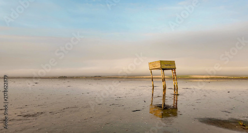 Lindisfarne Causeway refuge box reflected in tidal mudflats
