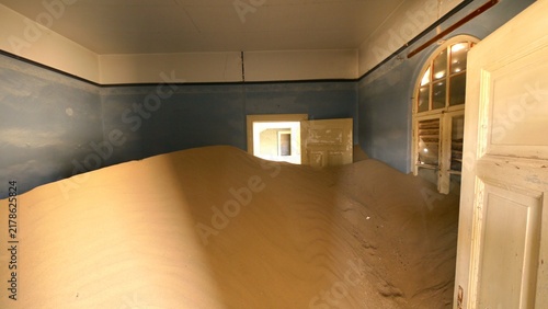 kolmanskop, old german diamond ghost town in Namibia, sand dunes inside historic houses  
