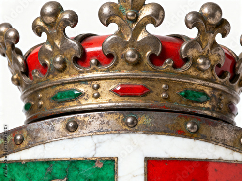 Ornate golden medieval crown featuring polished red velvet and sparkling green gems on white background