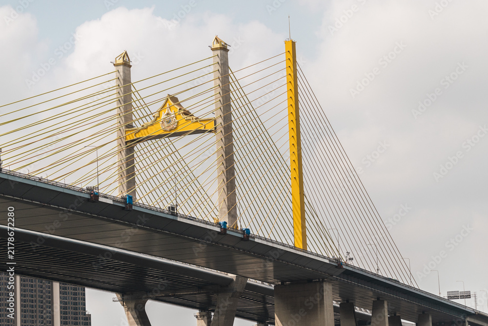 Naklejka premium Yellow Cable-Stayed Bridge Tower Framed from Below in Bangkok