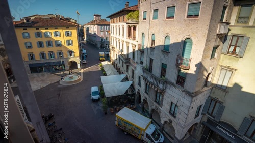 Time lapse of moving shadows across historic European town square architecture with outdoor cafe and fountain in bright morning sunlight