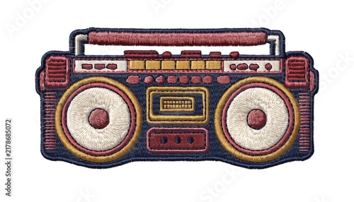 Vintage embroidered retro boombox patch, classic 1980s portable stereo with two large speakers, cassette deck and chunky control buttons, detailed layered thread embroidery, textured woven fabric