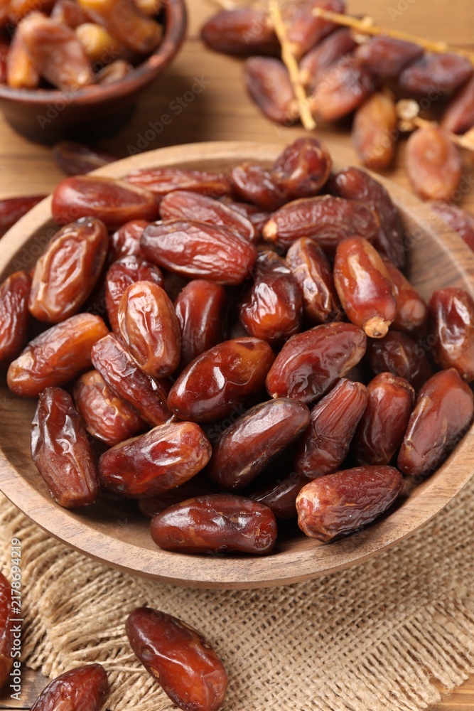 Fototapeta premium Tasty dried dates and bowl on table, closeup