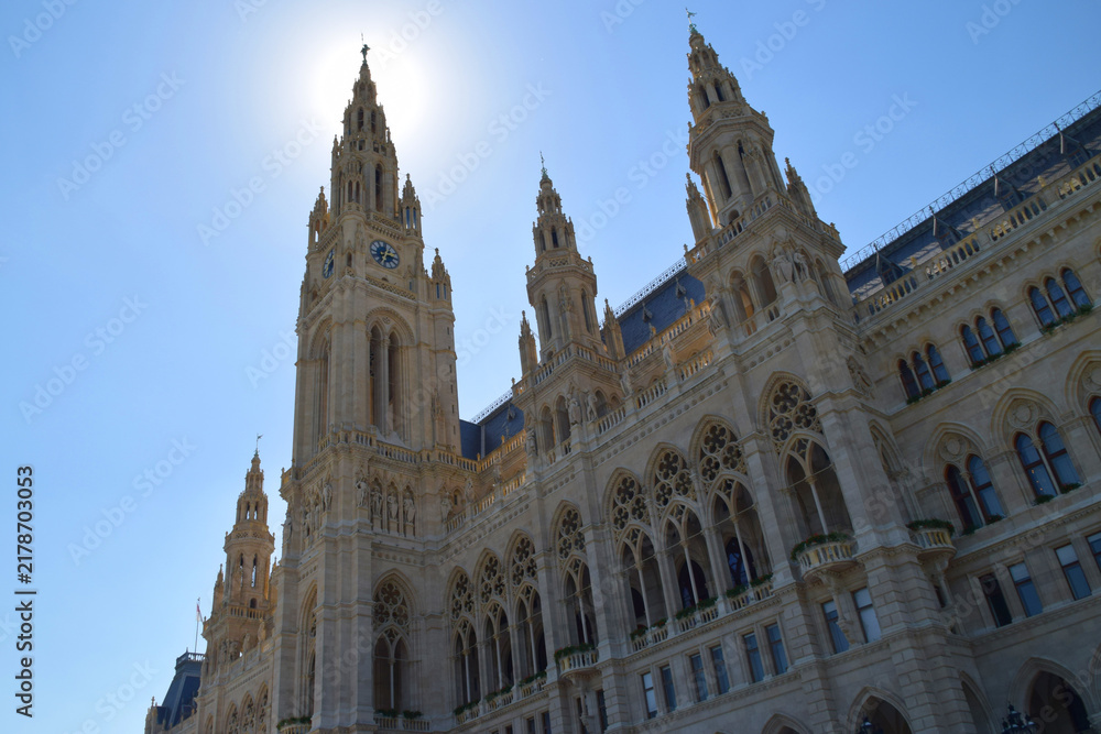Fototapeta premium Vienna City Hall towers rising into the blue sky in backlight
