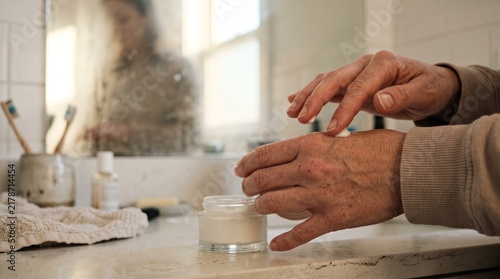Close-up shot of hands working in a bright kitchen or workshop preparing ingredients or food with soft lighting and copy space.