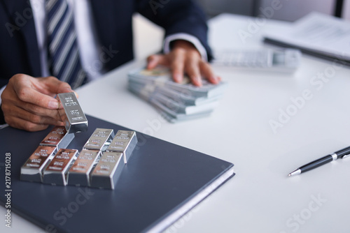 Silver Trading Businessman invest in trading silver, calculating profit price of  buying and selling silver in the market.