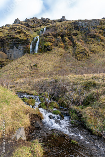 Seljalandsfoss waterfall in Iceland. Popular and beautiful waterfall along Route 1 and Ring Road. Seljalands River waters. Visitors can walk behind the falls and into cave. 