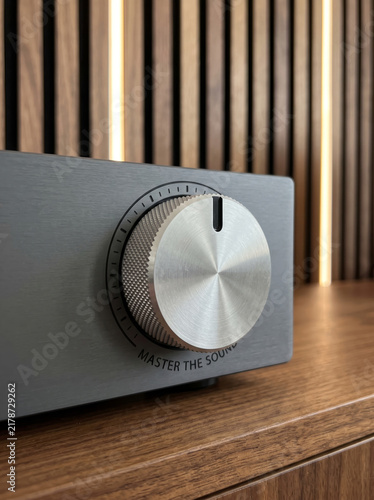 Fotografie Brushed Metal Rotary Volume Knob On Minimalist Stereo Audio Amplifier