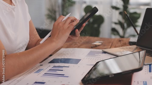 Businessman analyzing financial documents and charts on laptop