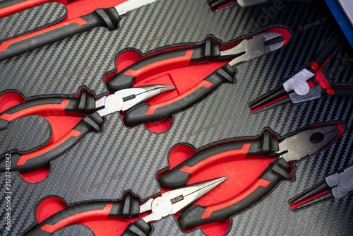 Fotografie Pliers tool set rests in fitted foam case, with red, black handles nested in shaped cutouts