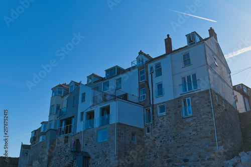 Obraz na plátně A large, multi-story building with a stone base and white upper floors, featurin