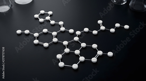 Medical pills arranged to form a chemical molecular structure on a dark background.