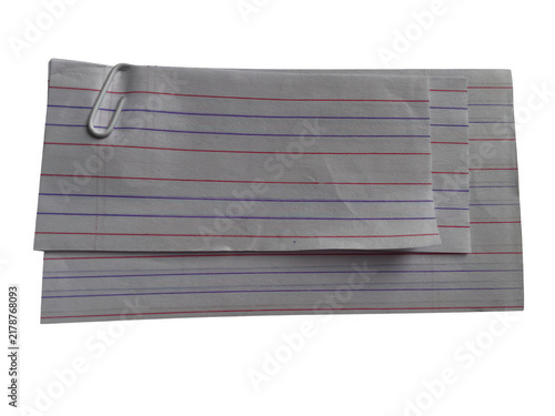 Abstract grey paper shopping bag with vertical red and blue lines and a metal clip on a simple surface