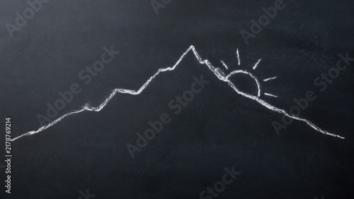 Chalk drawing of a mountain range with a rising sun on a black chalkboard background, showcasing detailed peaks and rays of sunlight emanating from the sun